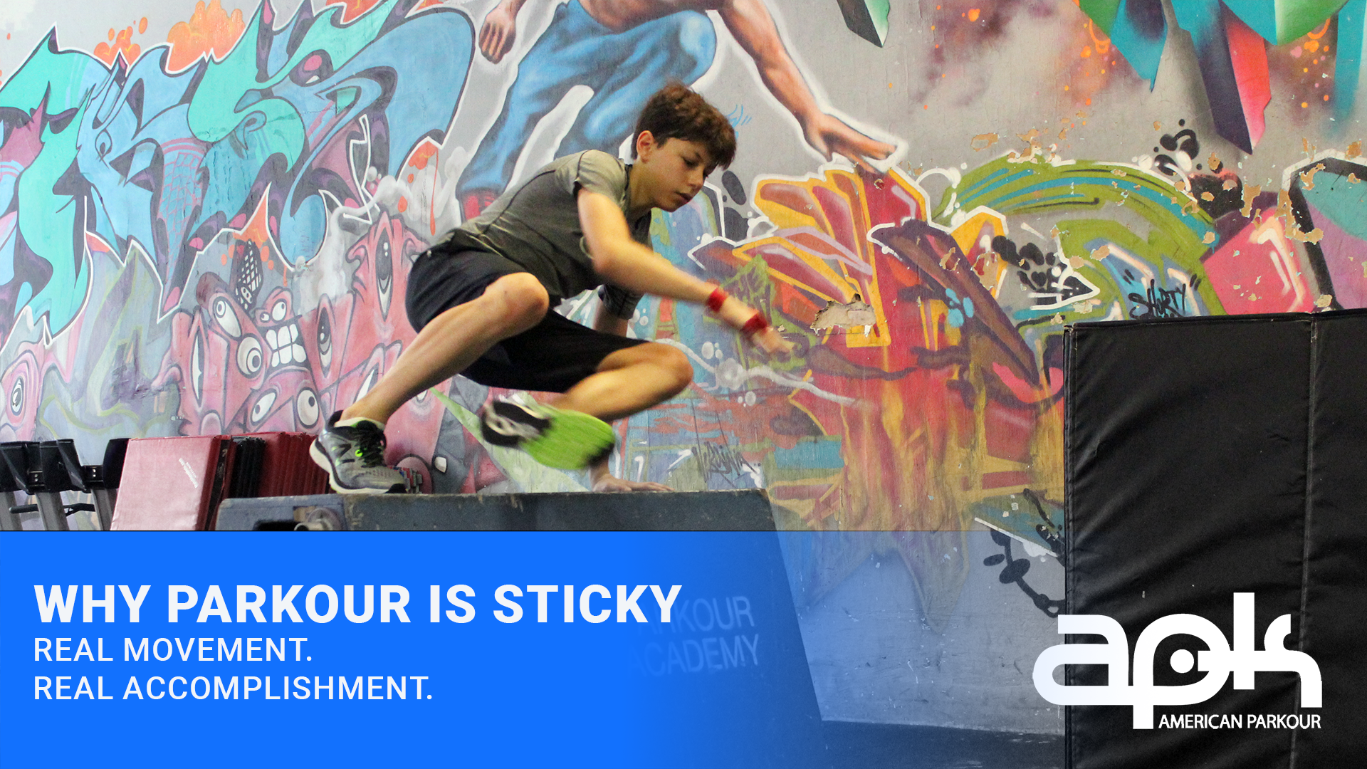 a student vaults over a box, concentration evident on his face